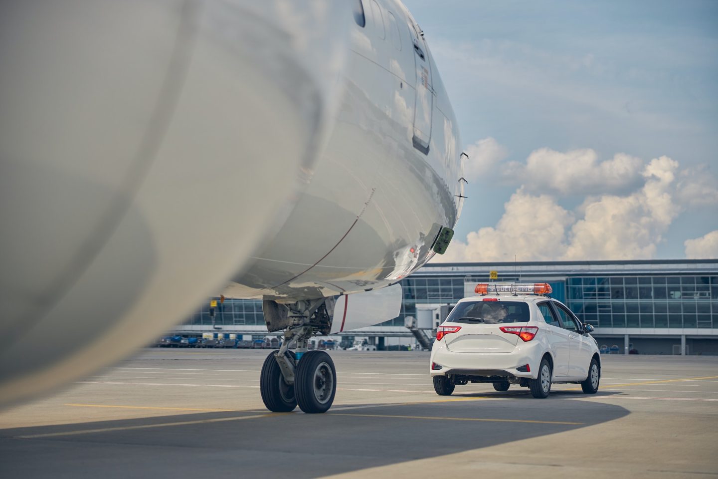 Landed airliner taxing after an airport car